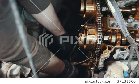 Mechanic cleans and wipes the car engine parts Mechanic cleans and wipes the car engine parts 37131506