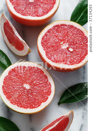 Close-up of grapefruits on white marble. 37134265