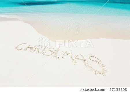 Handwritting inscription word CHRISTMAS on beach 37135808