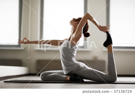 Young sporty woman doing yoga stretching exercise 37136729