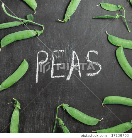Fresh green peas on black chalk board Fresh green peas on black chalk board 37139703