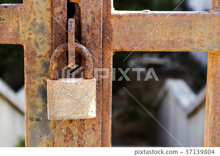 Closeup a blue rusty old metal door locked with a Closeup a blue rusty old metal door locked with a 37139804