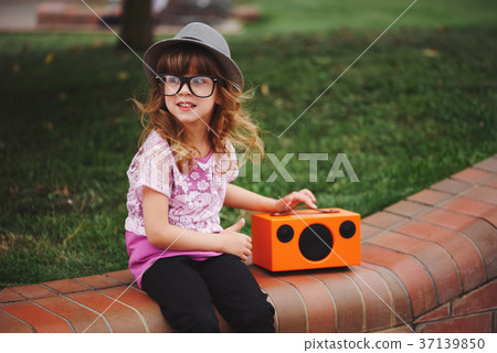 little hipster girl listens music on wireless 37139850