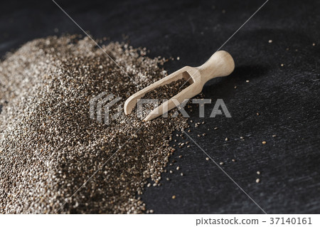 Heap of chia seeds over dark background Heap of chia seeds over dark background 37140161