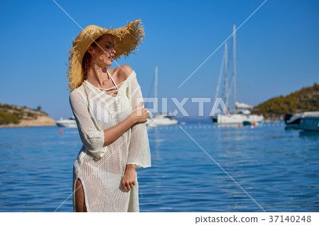 Sexy beautiful woman in white bikini on Mediterranean sea coast 37140248