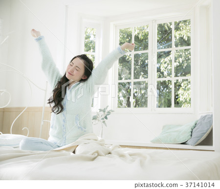 Girl stretching to get up asleep 37141014
