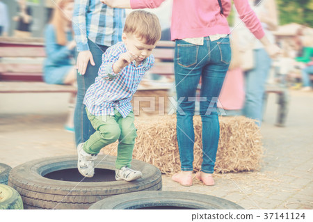 Boy Playing Jumping Tires on Street Festival 37141124