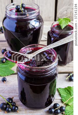 Black currant jam on a wooden background 37141194