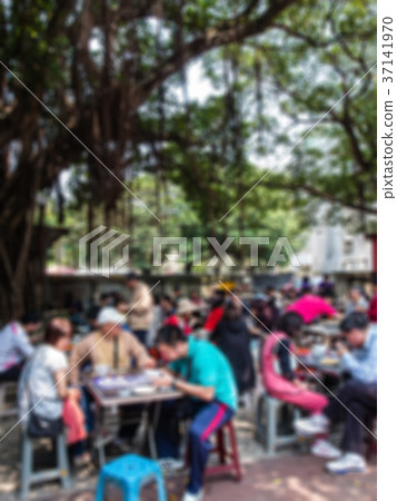 People sitting under old trees and eating People sitting under old trees and eating 37141970