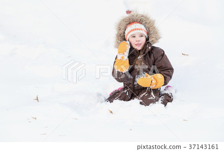 Beautiful little girl playing in snow Beautiful little girl playing in snow 37143161
