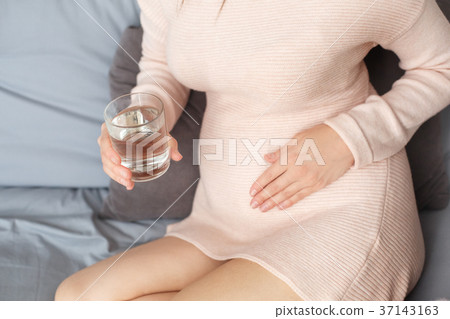 Young pregnant woman on the sofa at home in winter 37143163