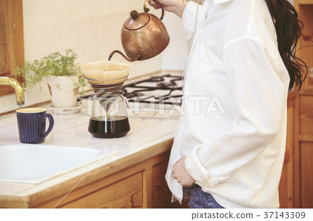 Girl dripping hand while listening to music 37143309