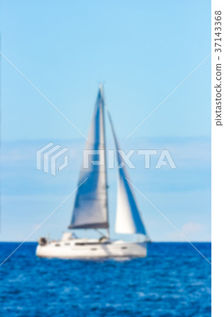Blue sailboat - blurred image Blue sailboat - blurred image 37143368