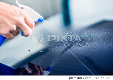 Hand spraying cleaning substance on the surface of Hand spraying cleaning substance on the surface of 37143976