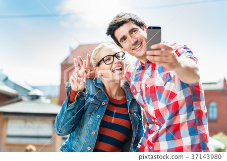 Tourist couple taking selfie on rooftop in Berlin Tourist couple taking selfie on rooftop in Berlin 37143980