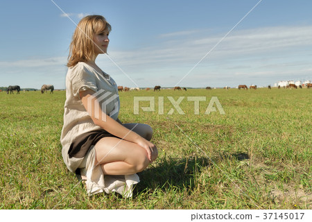 Attractive girl relaxes on meadow Attractive girl relaxes on meadow 37145017
