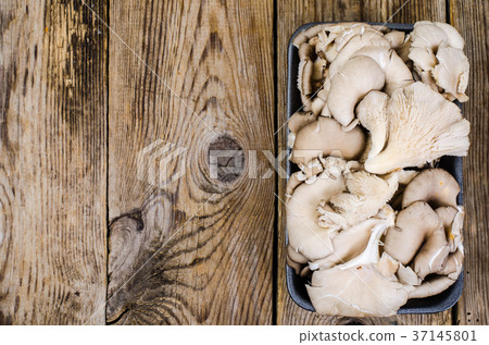 Fresh oyster mushrooms in black package 37145801