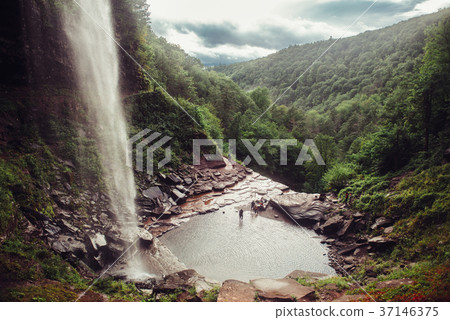 Scenic view on mountain waterfall cave in forest 37146375