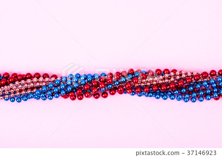 Multi color Mardi Gras beads on bright background 37146923