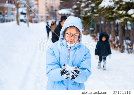 Happy asian teenager enjoying herself playing snow Happy asian teenager enjoying herself playing snow 37151118