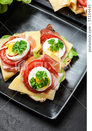Delicious sandwich with prosciutto ham Delicious sandwich with prosciutto ham 37154445