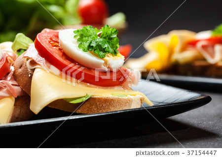Delicious sandwich with prosciutto ham Delicious sandwich with prosciutto ham 37154447
