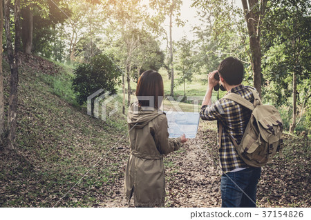 Two Young Traveler with backpack, are holding map relaxing in gr 37154826