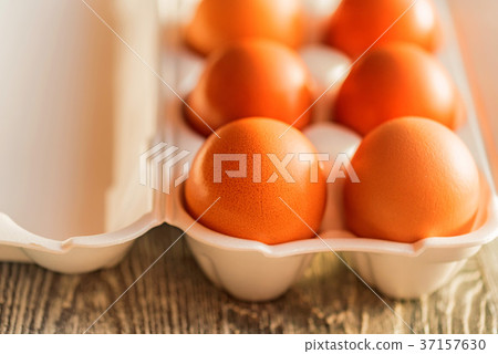 Fresh farm brown eggs on rustic background 37157630