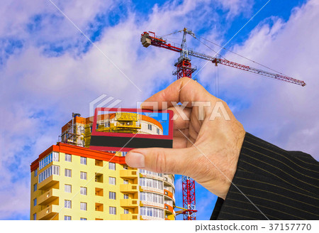 Hand with house and credit card, buy house concept Hand with house and credit card, buy house concept 37157770