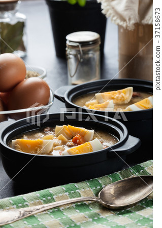 The sour soup made of rye flour with eggs 37158673
