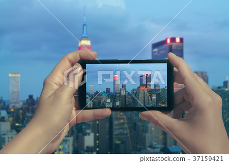Female take picture of Manhattan on mobile phone Female take picture of Manhattan on mobile phone 37159421