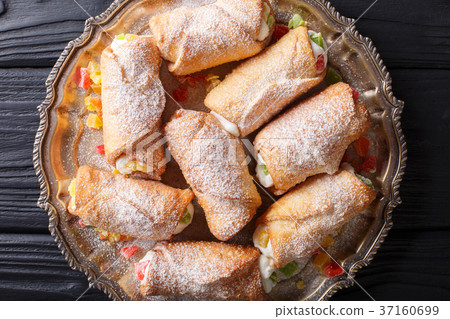 Italian cannoli dessert with a delicate cheese Italian cannoli dessert with a delicate cheese 37160699