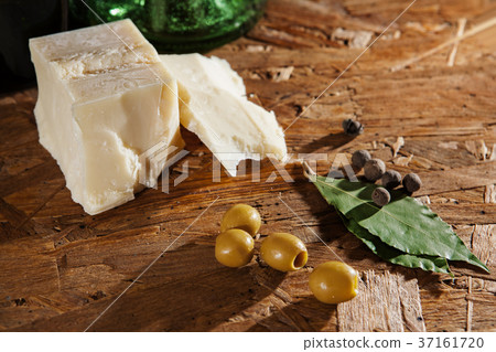 cheese and olives on wooden surface 37161720