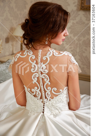 Wedding. Bride in beautiful dress sitting on sofa 37163604