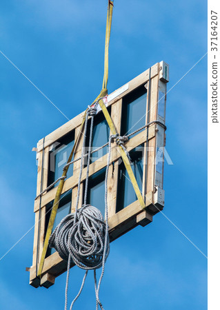 Wooden window frame on the building crane on the Wooden window frame on the building crane on the 37164207