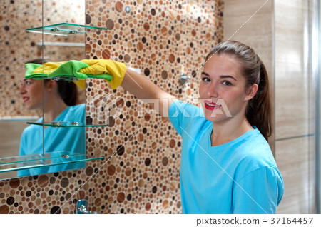 Female employee doing cleaning in bathroom Female employee doing cleaning in bathroom 37164457