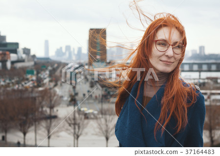 Young woman with red hair in front of New York Young woman with red hair in front of New York 37164483