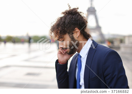 Jocund mulatto guy raving near Eiffel Tower and Jocund mulatto guy raving near Eiffel Tower and 37166882