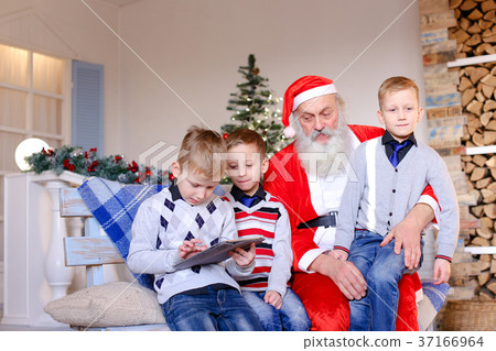 Little boys  with Santa Claus playing with tablet. 37166964