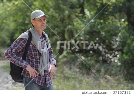 Man with backpack outdoors 37167351