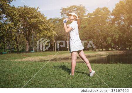 Asian woman golf player swinging driver golf club Asian woman golf player swinging driver golf club 37167463