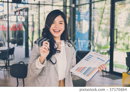 confident businesswoman shows analytic accounting market chart and graph. woman present financial report summary. business statistics performance concept 37170864
