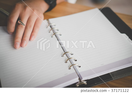 man's hand holding pen at office. student learning lesson with notebook. business, education concept man's hand holding pen at office. student learning lesson with notebook. business, education concept 37171122