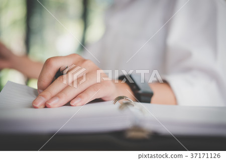 man's hand holding pen at office. student learning lesson with notebook. business, education concept 37171126