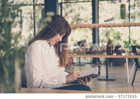 start up woman work in cafe. female student write note in notebook in coffee shop. education, lifestyle, business, people concept. 37171810