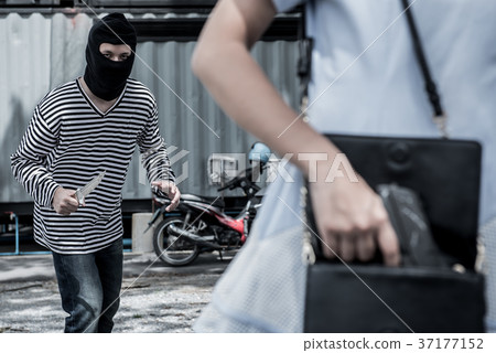 Thief is trying to steal at the public place Thief is trying to steal at the public place 37177152
