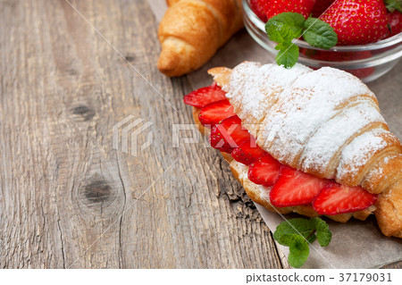 croissant with fresh strawberries, ricotta 37179031
