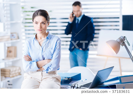 Emotional unhappy woman frowning while sitting on 37183631