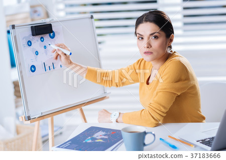 Serious busy woman working with diagrams and Serious busy woman working with diagrams and 37183666