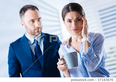 Beautiful woman touching her forehead while Beautiful woman touching her forehead while 37183670